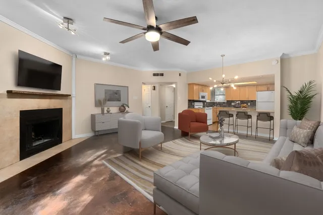 a living room with furniture a flat screen tv and a fireplace