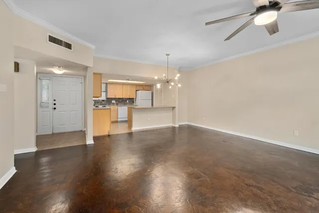 a view of a big room with wooden floor and a kitchen