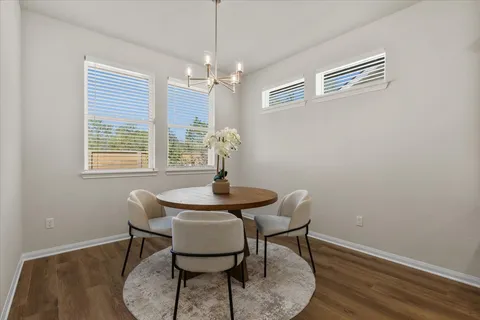 a kitchen with granite countertop a sink stove and cabinets