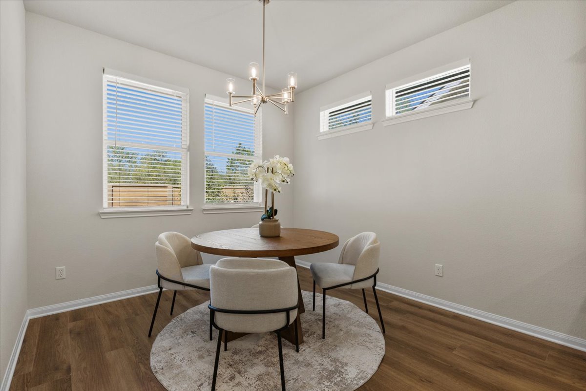 161 Spangle Way Kyle, TX 78640 - Photo 15 of 33 The dining area is bathed in natural light and framed by tree-lined views.