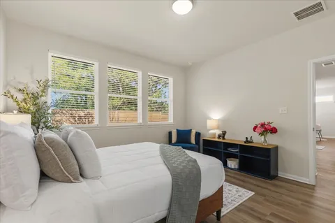 a bedroom with a bed and a potted plant