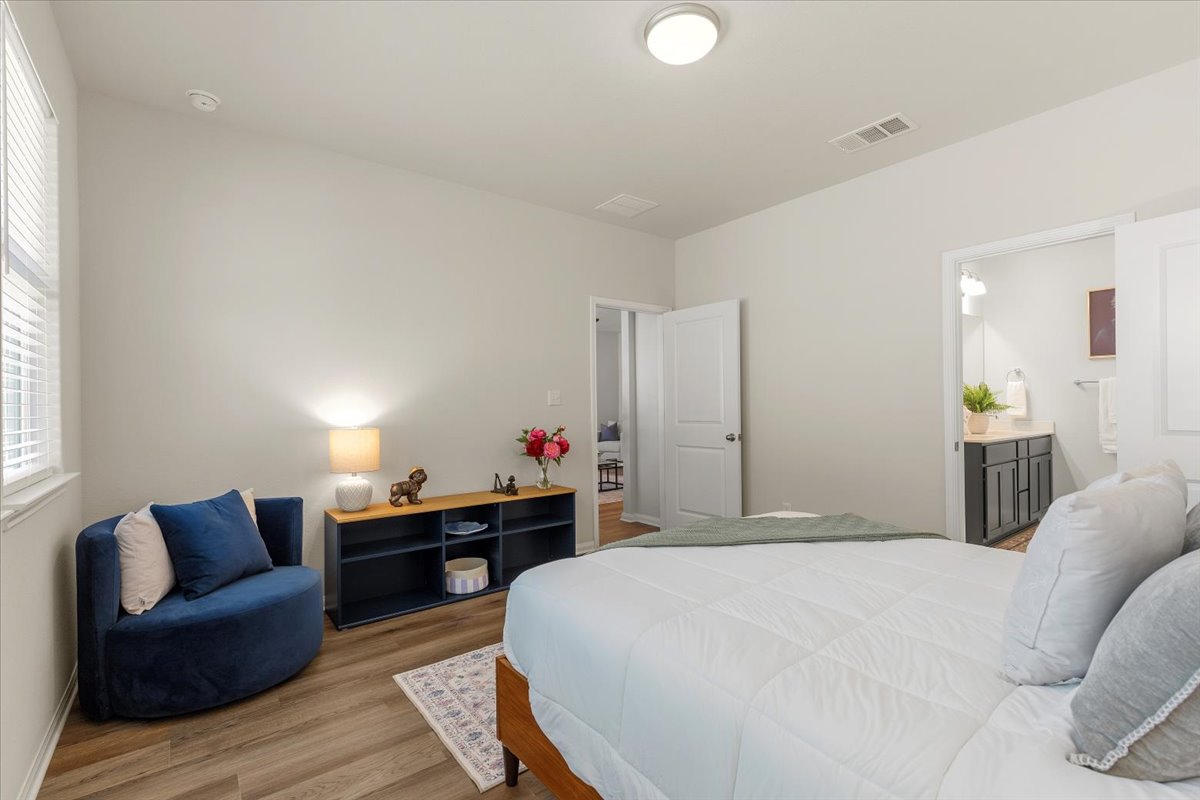 161 Spangle Way Kyle, TX 78640 - Photo 18 of 33 The primary bedroom is accompanied by an ensuite bath.