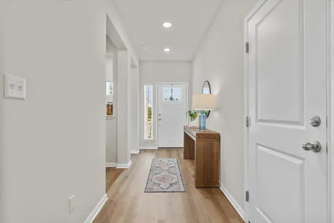 a view of hallway with wooden floor