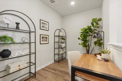 a view of a workspace with furniture and a potted plant