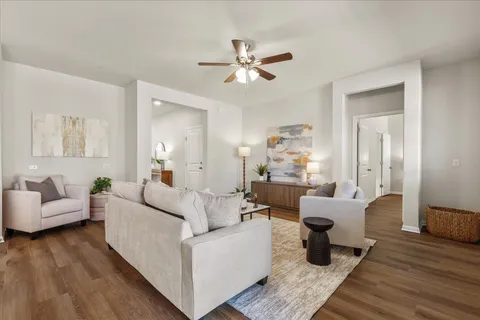 a living room with furniture and a potted plant