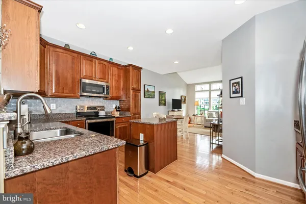 a spacious bathroom with a granite countertop sink and a mirror