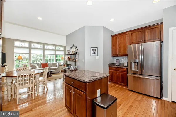 a kitchen with stainless steel appliances granite countertop a refrigerator and microwave