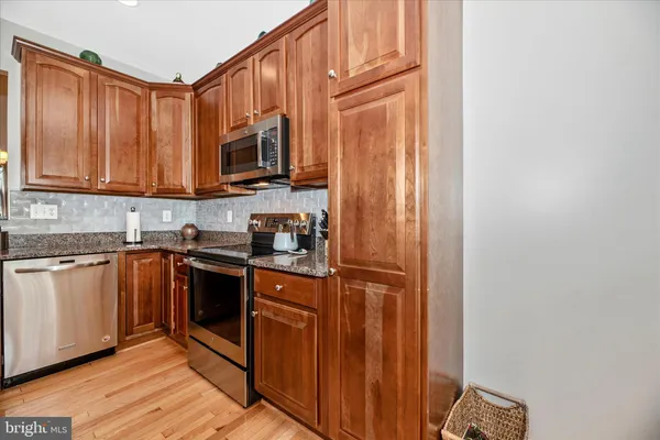 a view of a kitchen with furniture and wooden floor