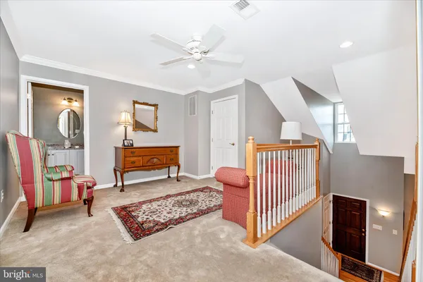a spacious bedroom with a bed and a chandelier