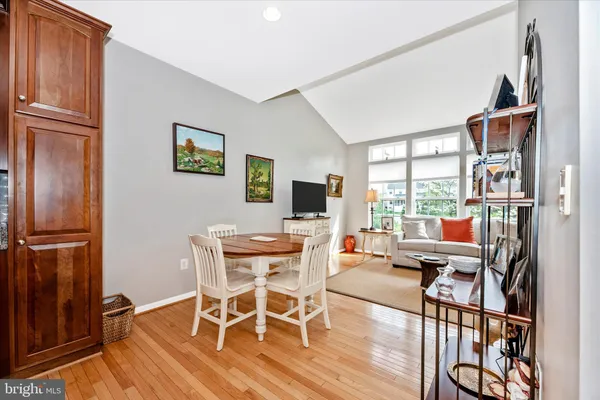a dining room with furniture a book and wooden floor