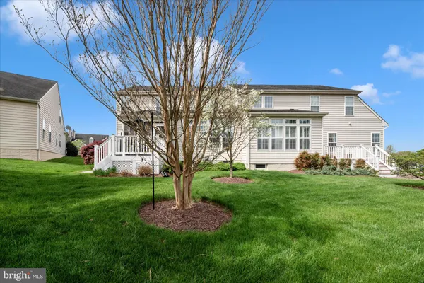 a view of a house with pool and a yard