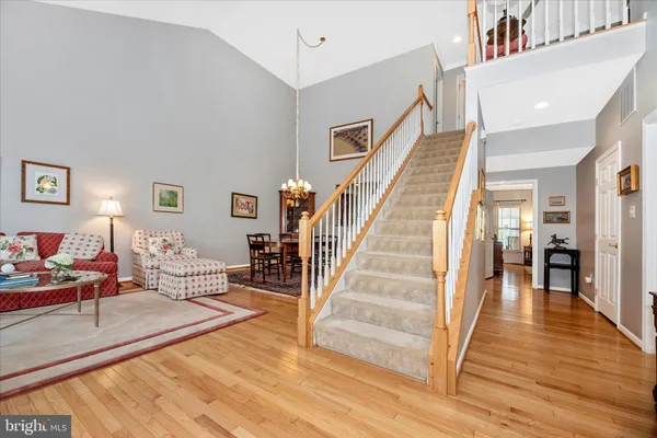 a kitchen with stainless steel appliances granite countertop a stove top oven a sink dishwasher and a refrigerator with wooden cabinets
