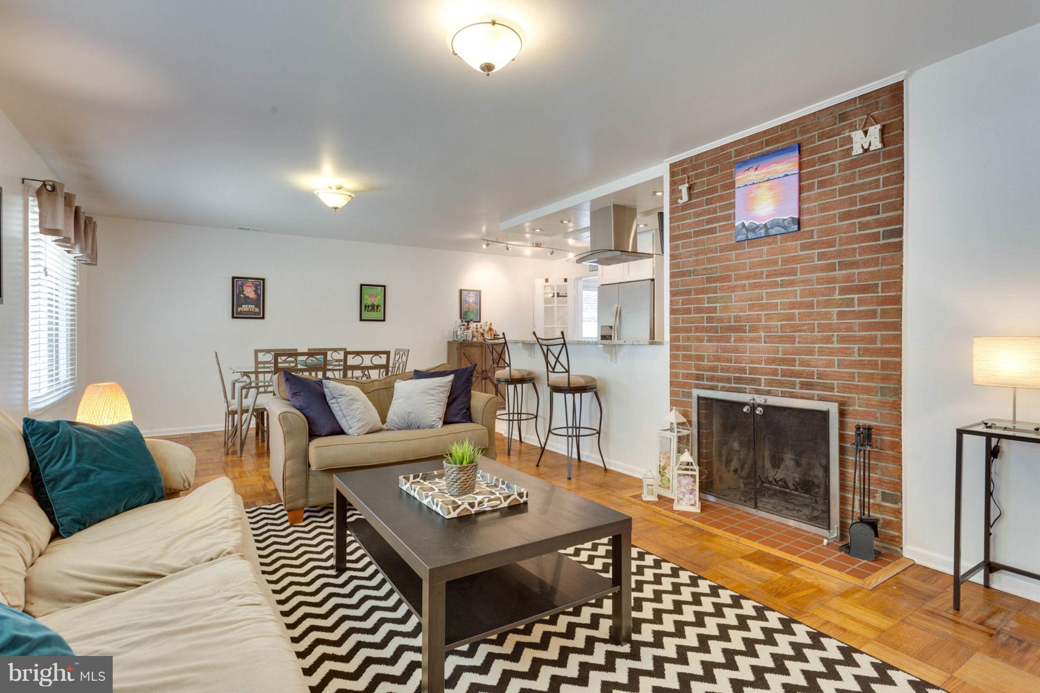 6405 Franconia Road Springfield, VA 22150 - Photo 5 of 26 Living room features fireplace w/ brick facade