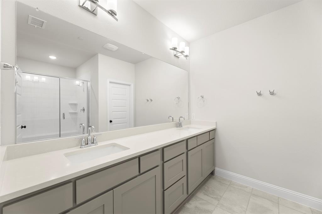 3916 Keya Drive Prosper, TX 75078 - Photo 21 of 28 a bathroom with a sink double vanity and a mirror