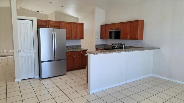 a kitchen with stainless steel appliances a refrigerator and a sink