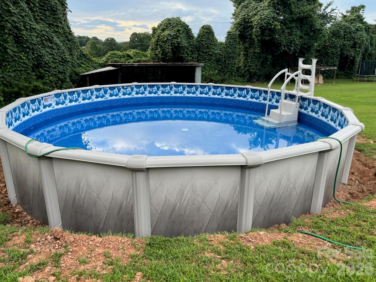 7723 Shoupes Grove Church Road Hickory, NC 28602 - Photo 13 of 24 a view of outdoor space with swimming pool and yard