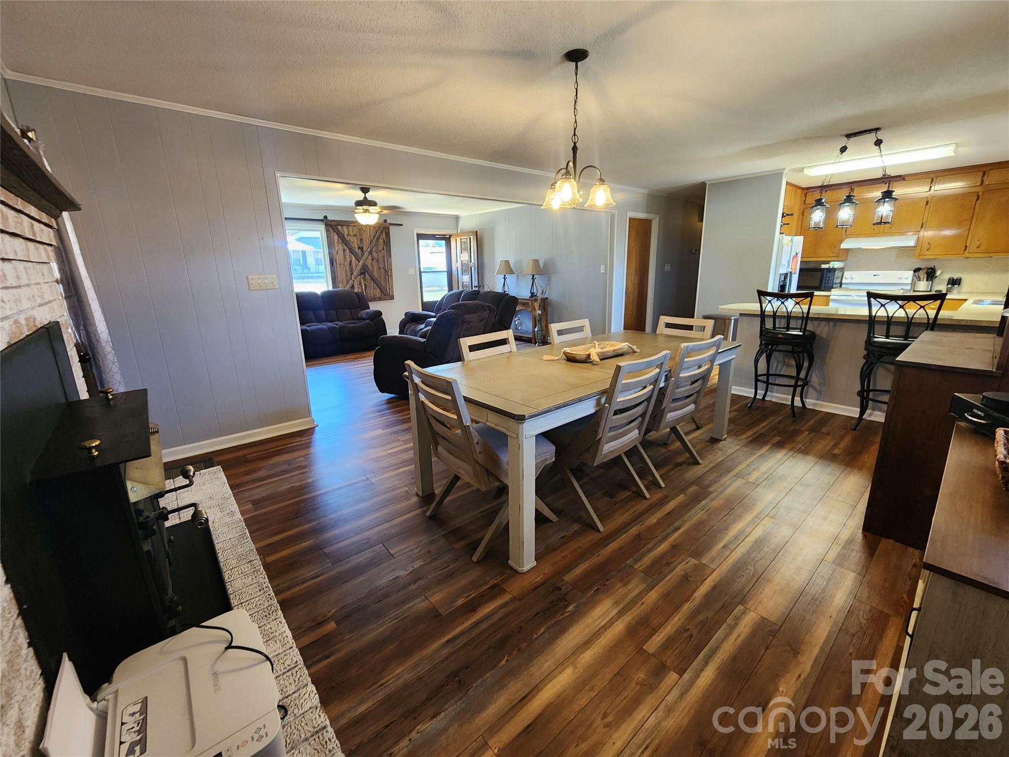 7723 Shoupes Grove Church Road Hickory, NC 28602 - Photo 3 of 24 a view of a dining room with furniture a chandelier and wooden floor
