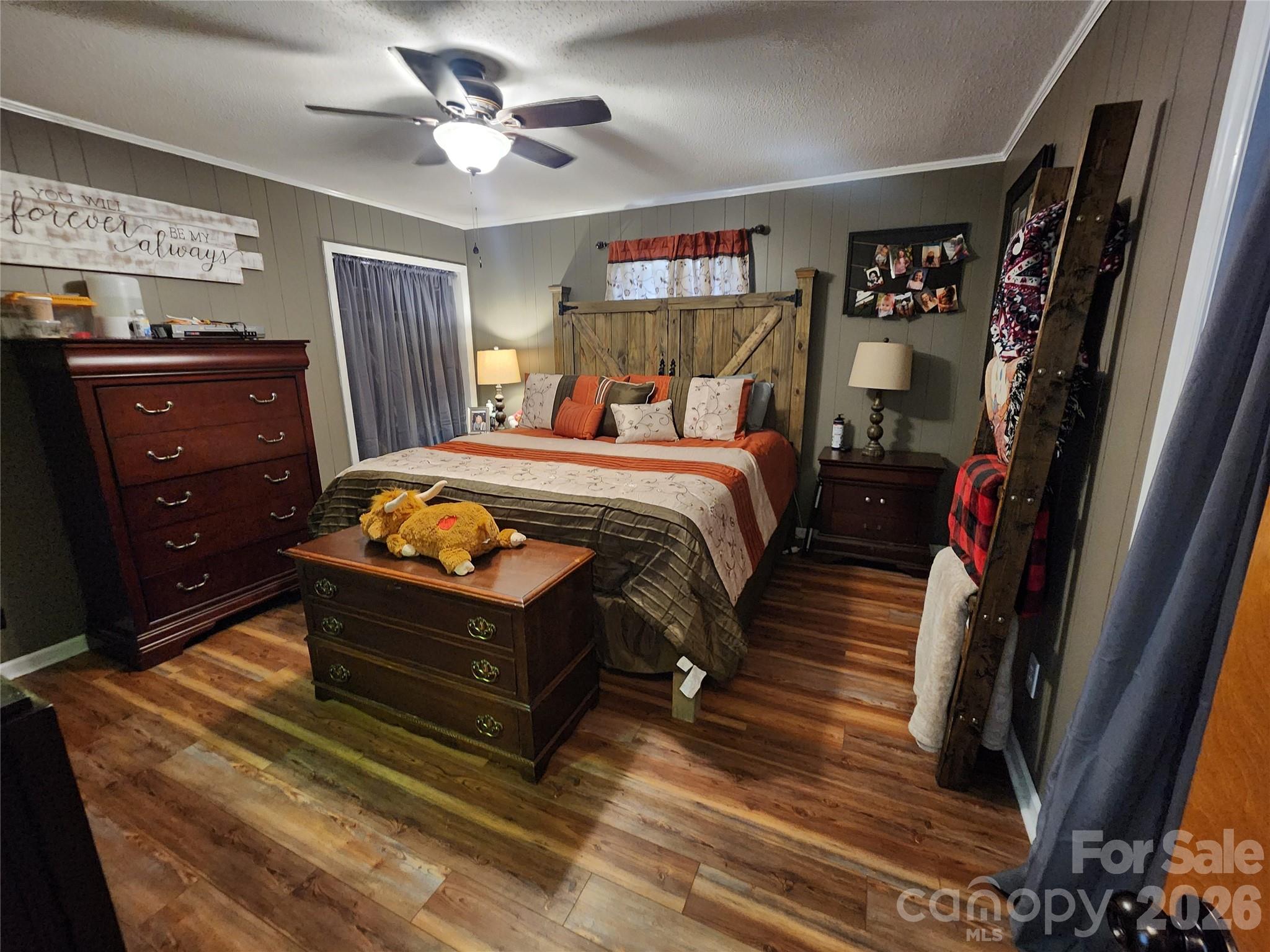 7723 Shoupes Grove Church Road Hickory, NC 28602 - Photo 6 of 24 a bed room with a bed and a chandelier