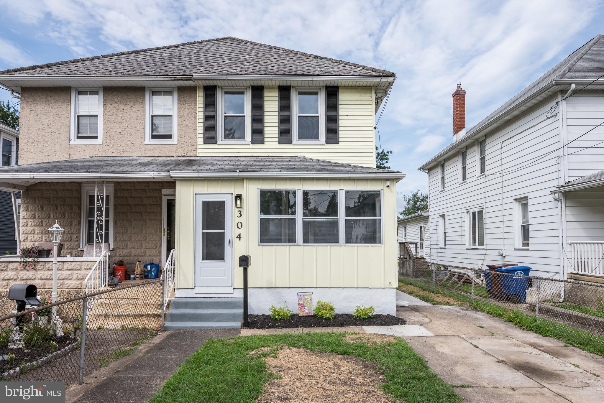 304 Cleveland Avenue Riverside, NJ 08075 - Photo 1 of 35 a front view of a house with a yard table and chairs