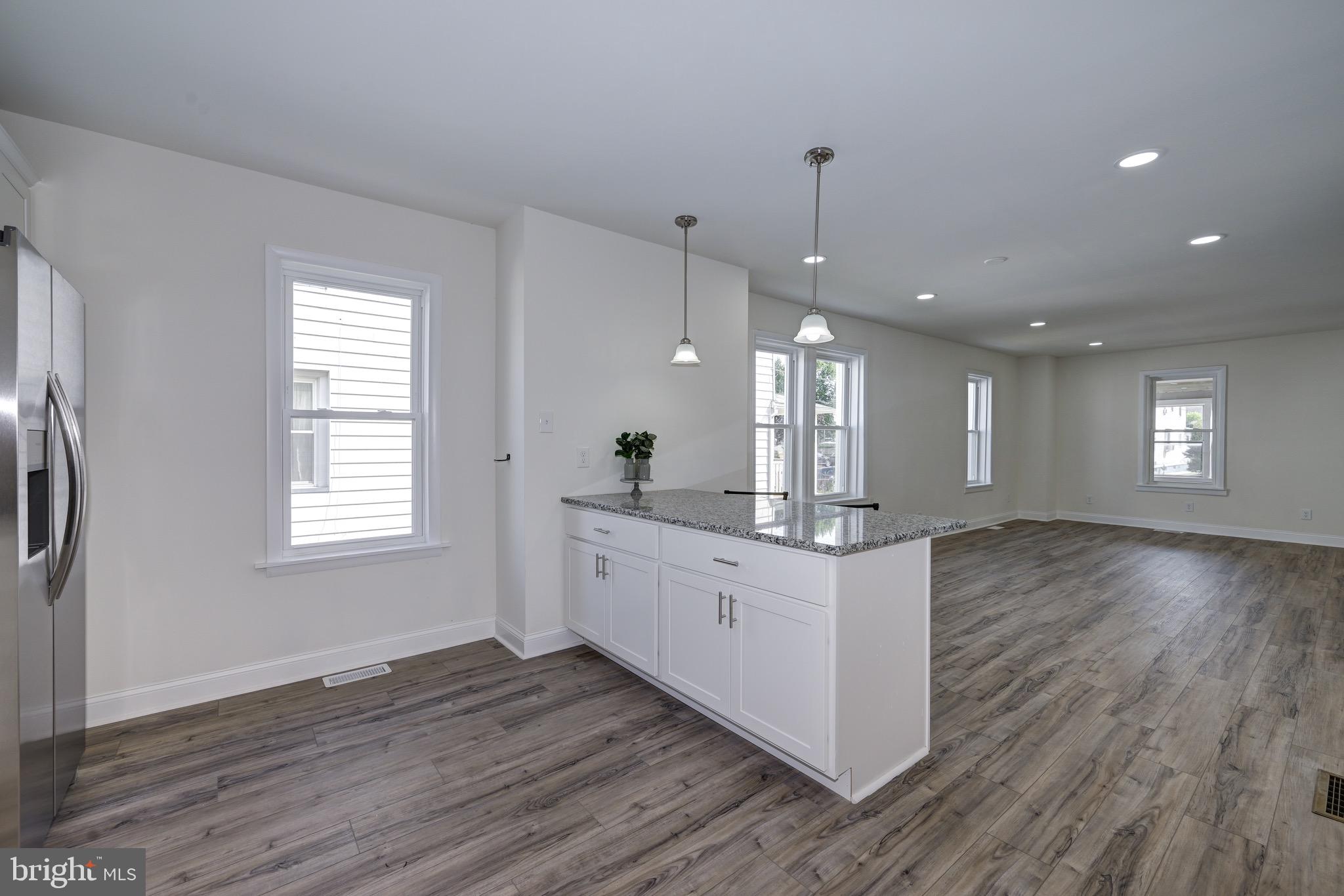 304 Cleveland Avenue Riverside, NJ 08075 - Photo 15 of 35 a kitchen with stainless steel appliances granite countertop wooden floors and white walls