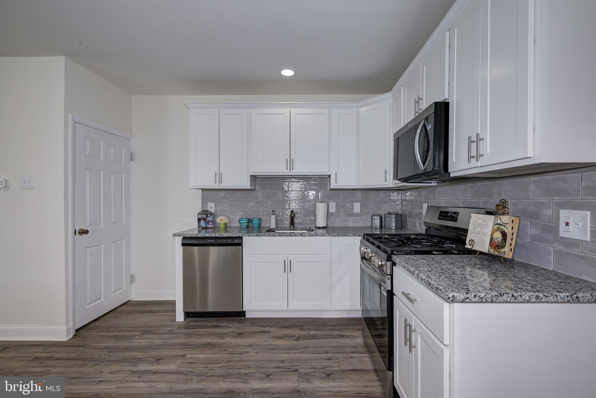 304 Cleveland Avenue Riverside, NJ 08075 - Photo 18 of 35 a kitchen with stainless steel appliances granite countertop a stove a sink and a microwave