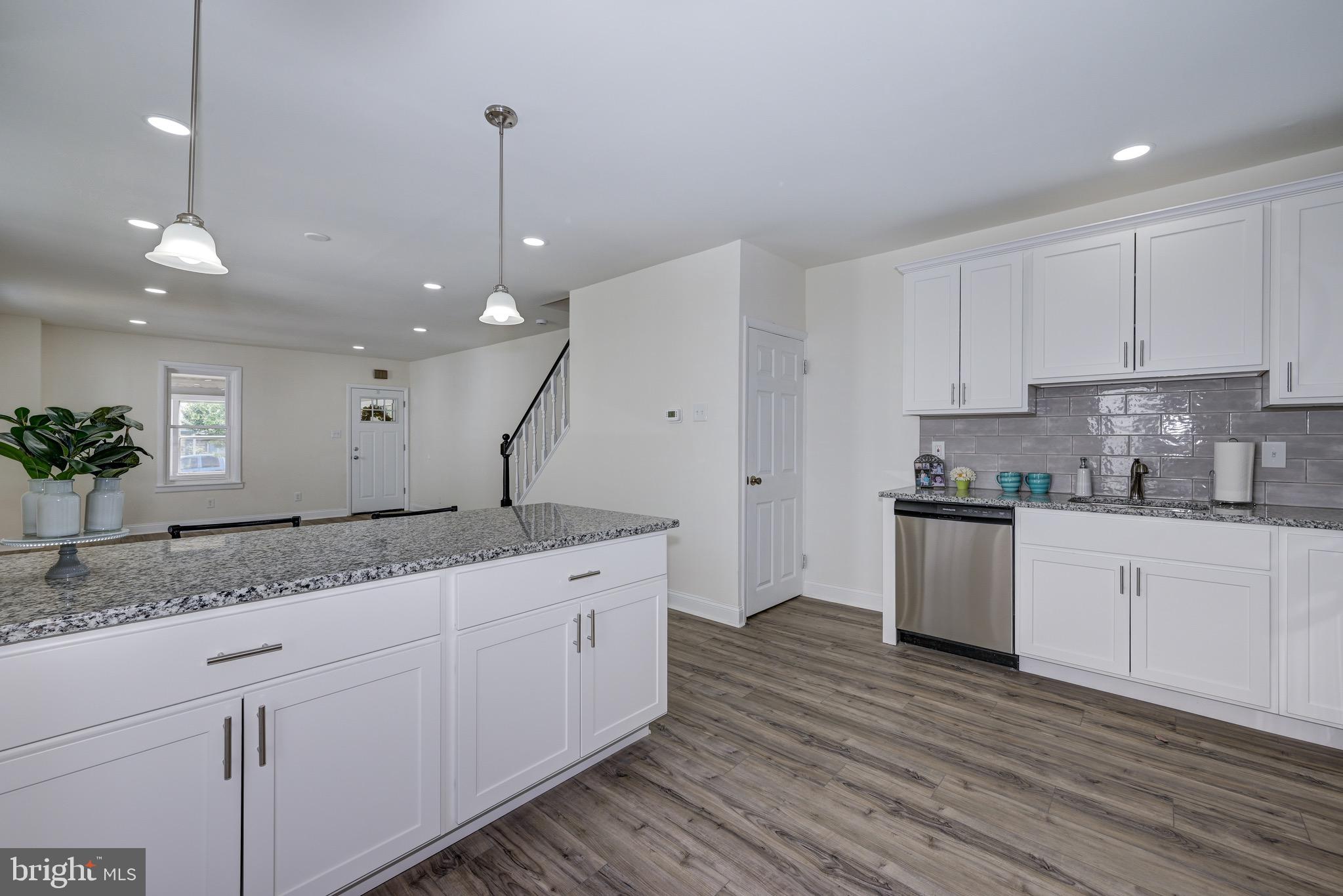 304 Cleveland Avenue Riverside, NJ 08075 - Photo 19 of 35 a kitchen with a sink dishwasher and white cabinets with wooden floor