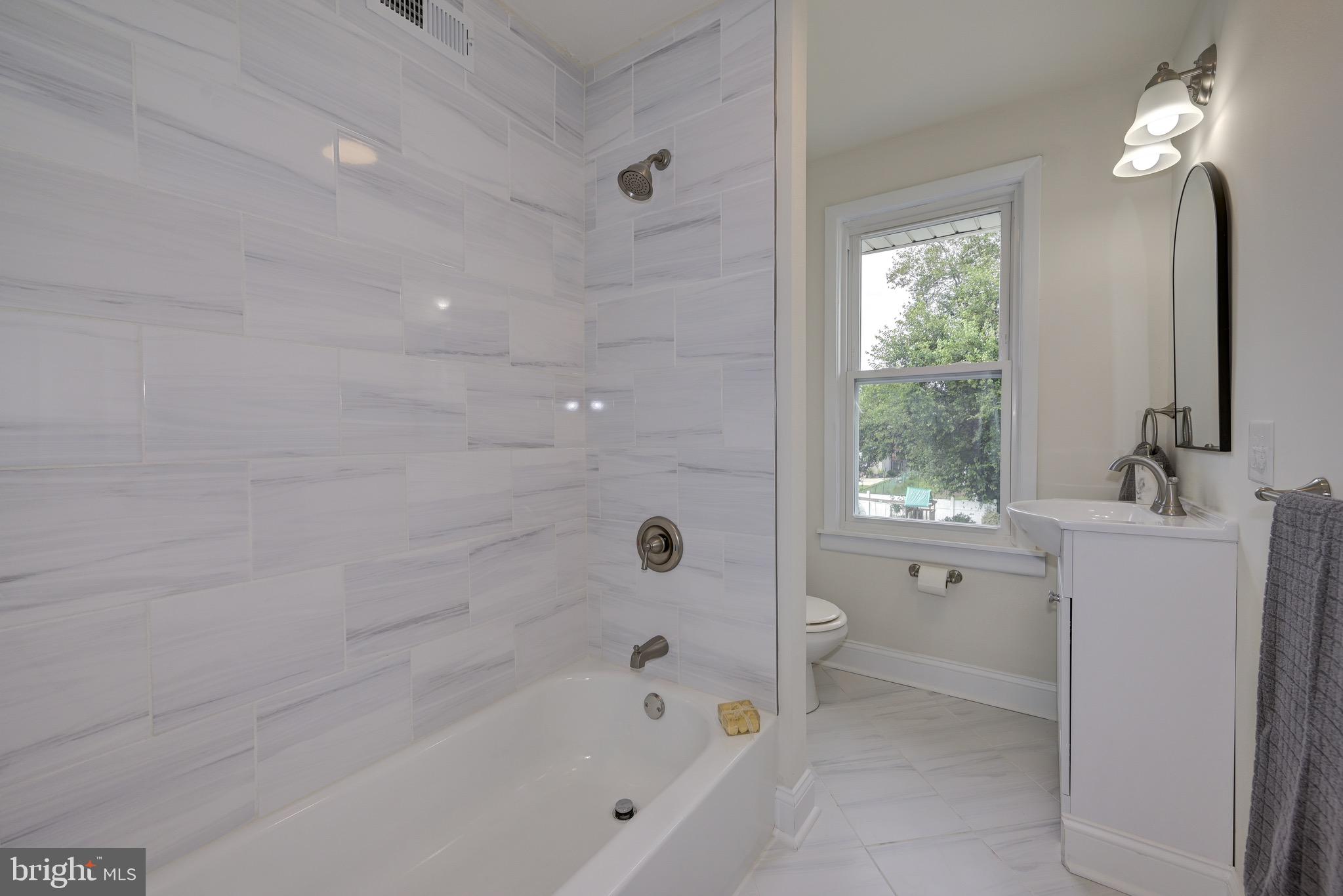 304 Cleveland Avenue Riverside, NJ 08075 - Photo 27 of 35 a bathroom with a bathtub a toilet and a shower