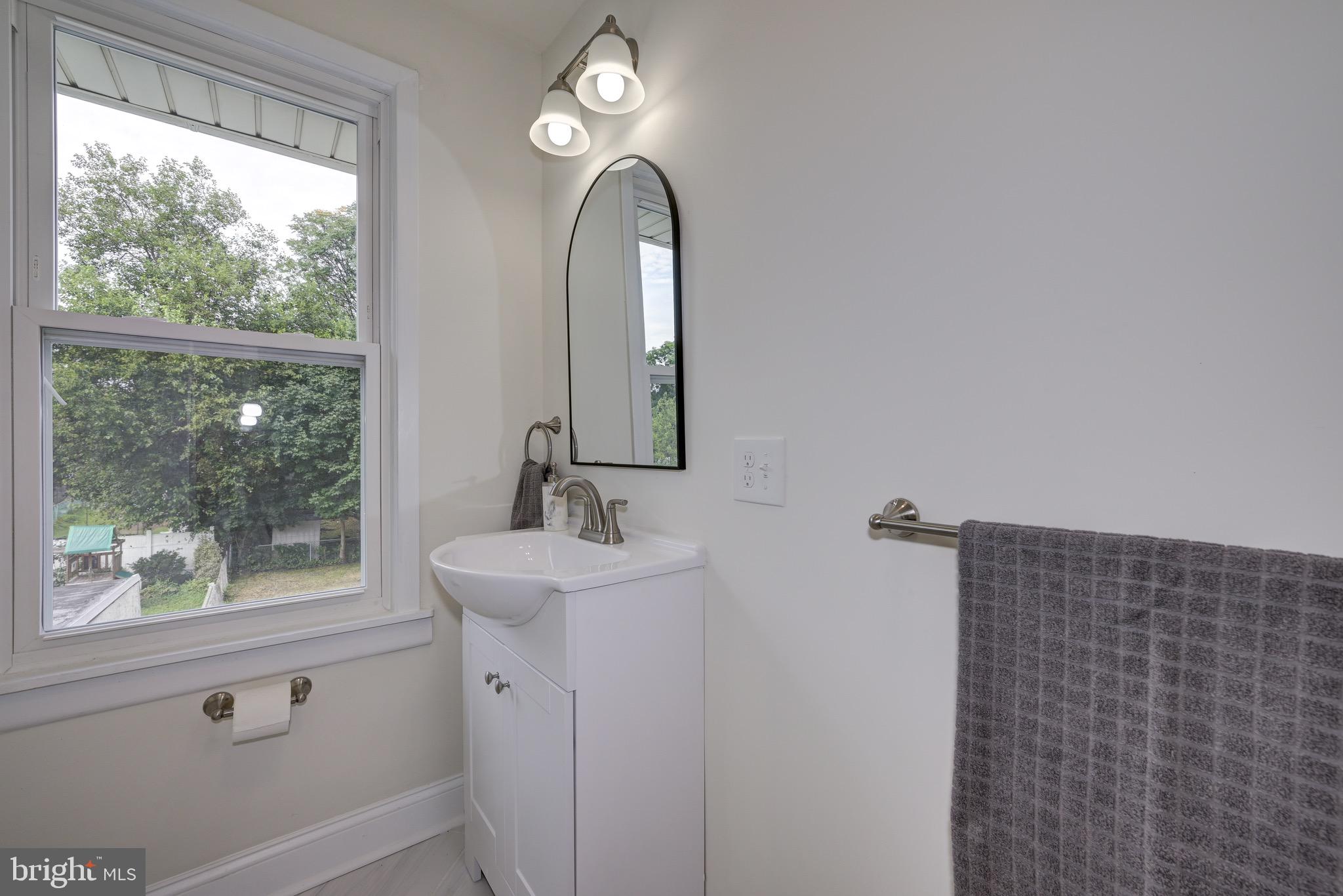 304 Cleveland Avenue Riverside, NJ 08075 - Photo 28 of 35 a bathroom with a sink and a mirror