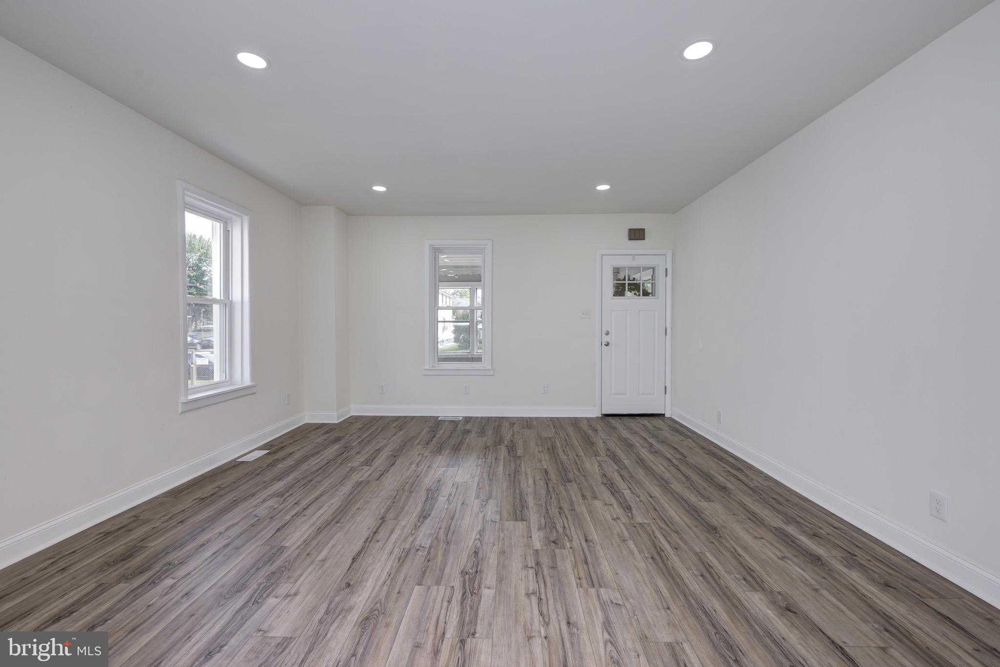 304 Cleveland Avenue Riverside, NJ 08075 - Photo 8 of 35 an empty room with wooden floor and windows