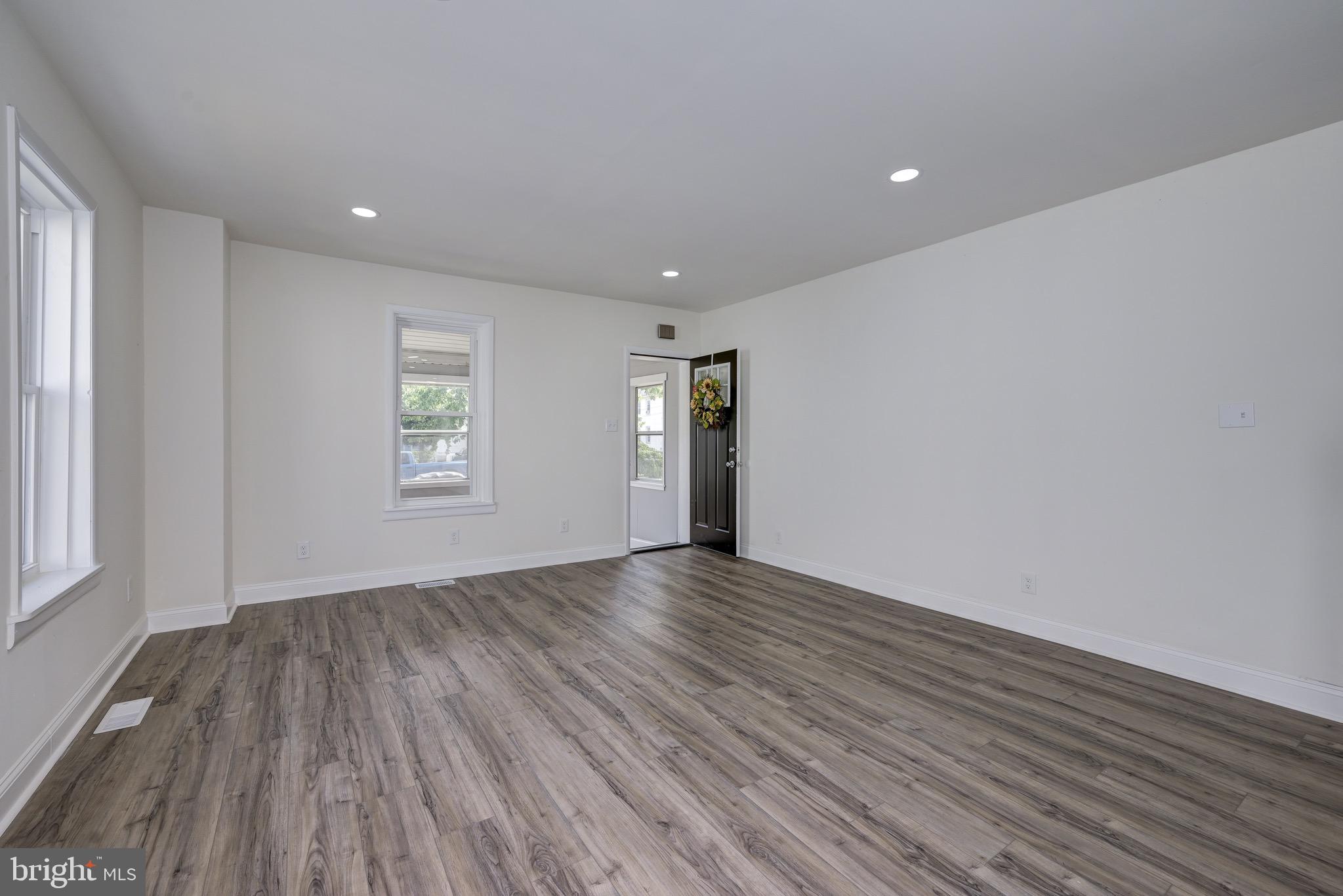 304 Cleveland Avenue Riverside, NJ 08075 - Photo 9 of 35 a view of an empty room with wooden floor and window