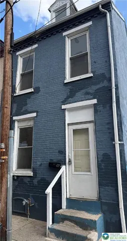 a front view of a house with stairs