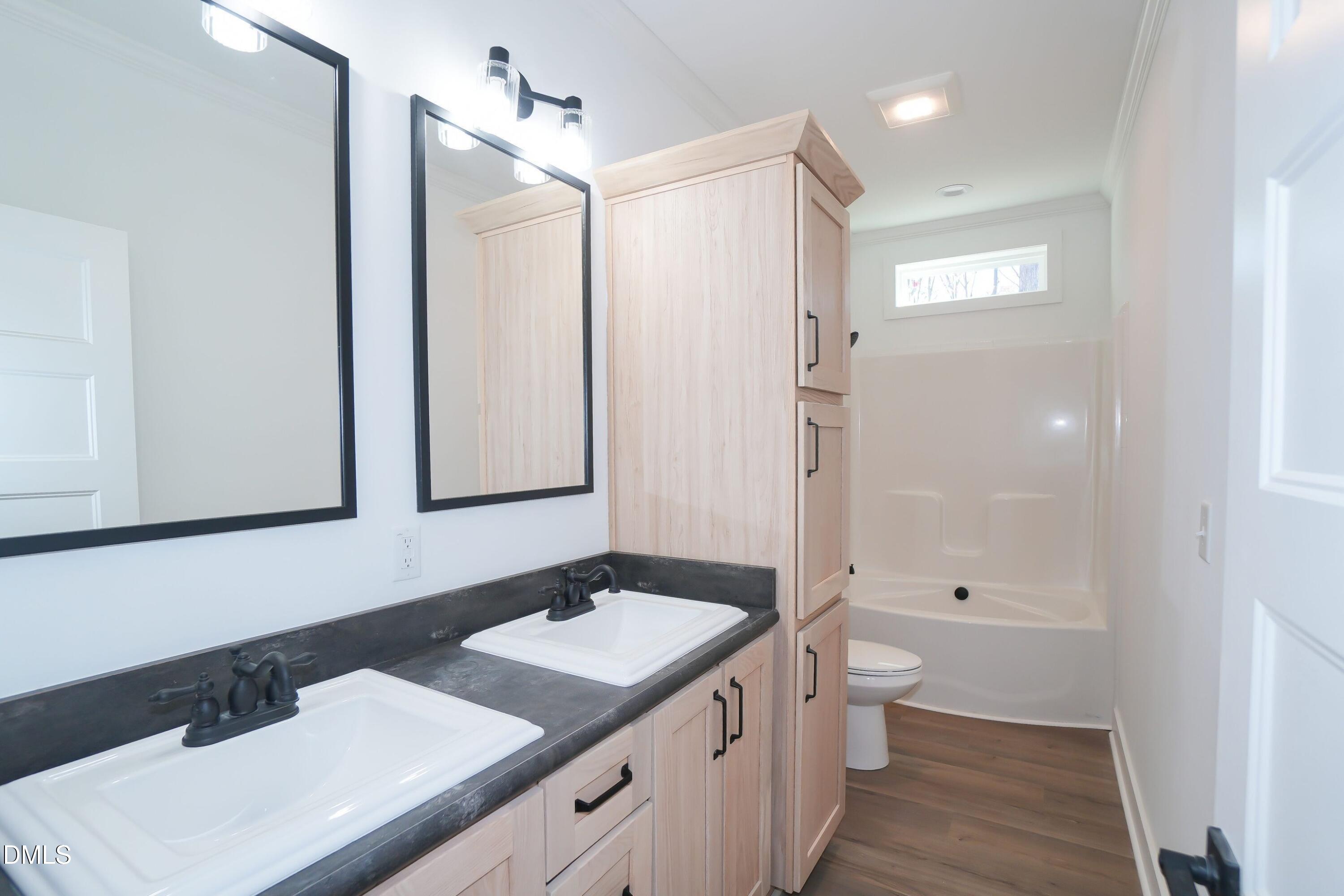 5430 Bass Mountain Road Snow Camp, NC 27349 - Photo 14 of 14 a bathroom with a sink a toilet and shower