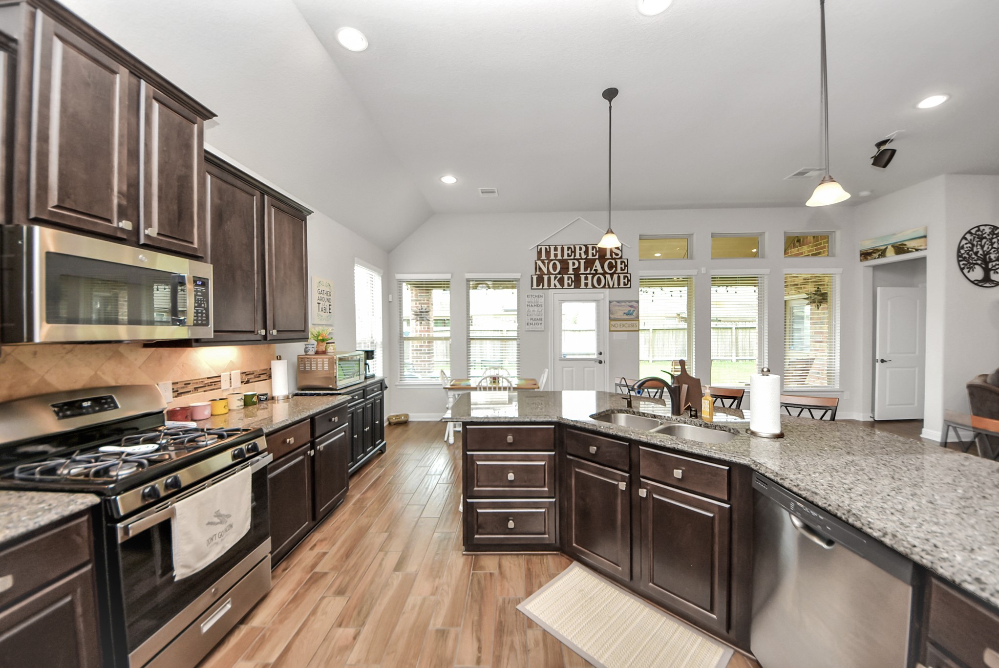24503 Eucalyptus Way Spring, TX 77373 - Photo 18 of 27 a kitchen with stainless steel appliances granite countertop a sink stove and cabinets