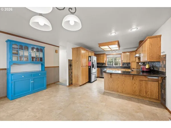 a open kitchen with stainless steel appliances granite countertop a granite counter tops and a refrigerator