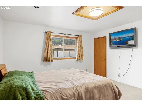a bedroom with a bed and a window
