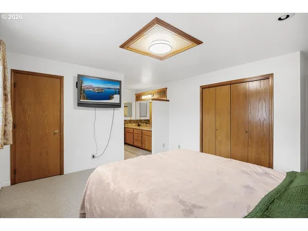 a bedroom with a bed and a flat screen tv