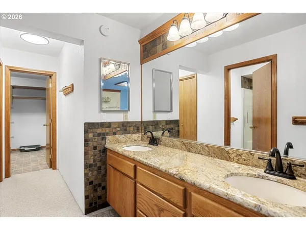 a bathroom with a granite countertop sink mirror and double