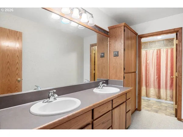a bathroom with a double vanity sink and a mirror