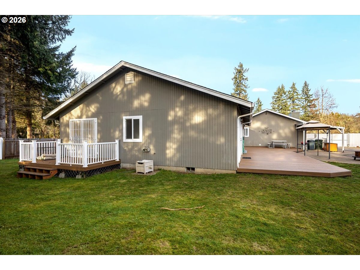 369 Upper Camp Loop Road Roseburg, OR 97470 - Photo 26 of 38 a backyard of a house with table and chairs