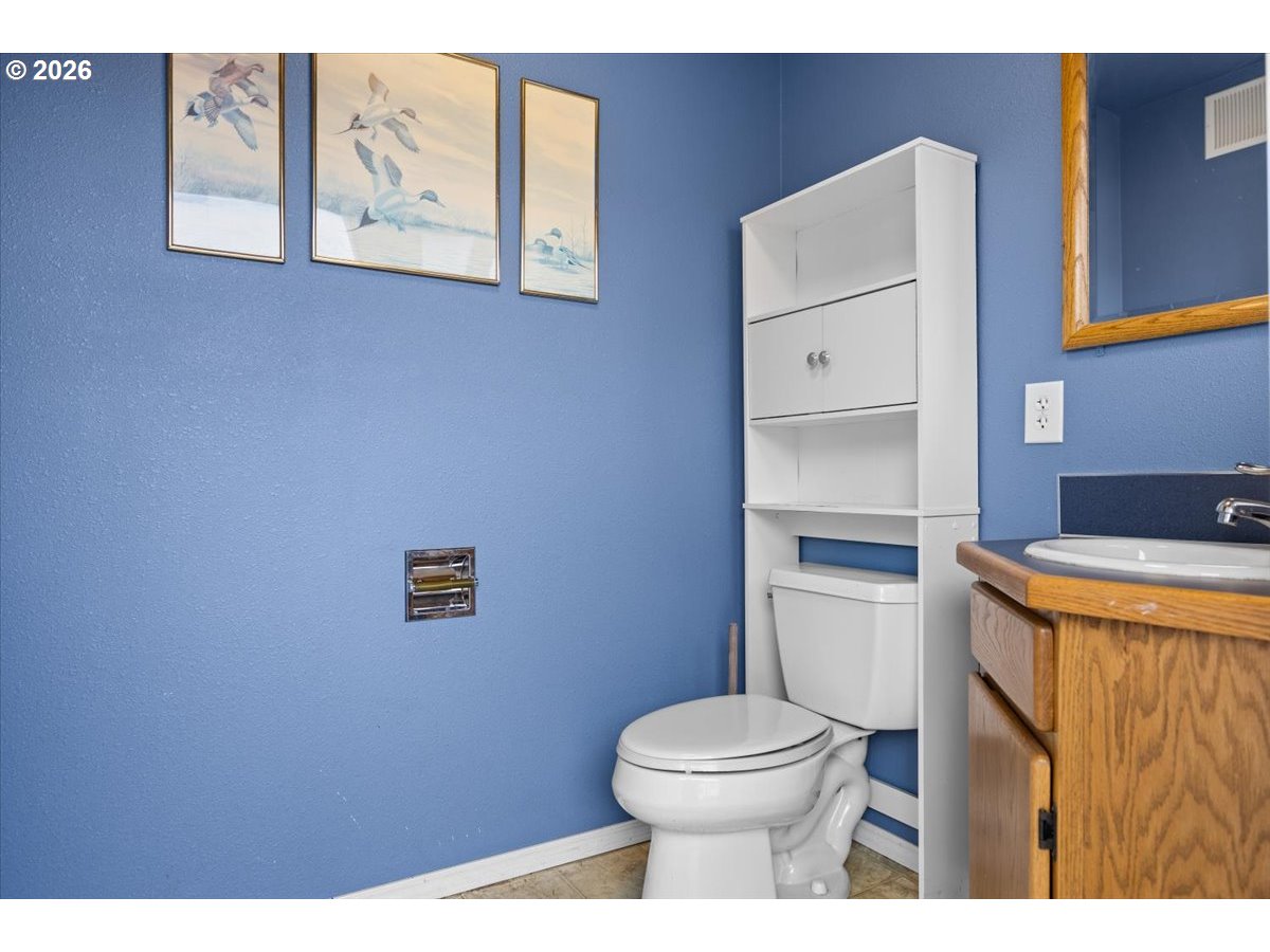 369 Upper Camp Loop Road Roseburg, OR 97470 - Photo 28 of 38 a bathroom with a toilet and a sink