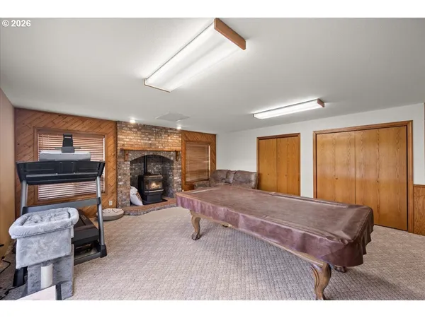 a living room with furniture a fireplace and a window