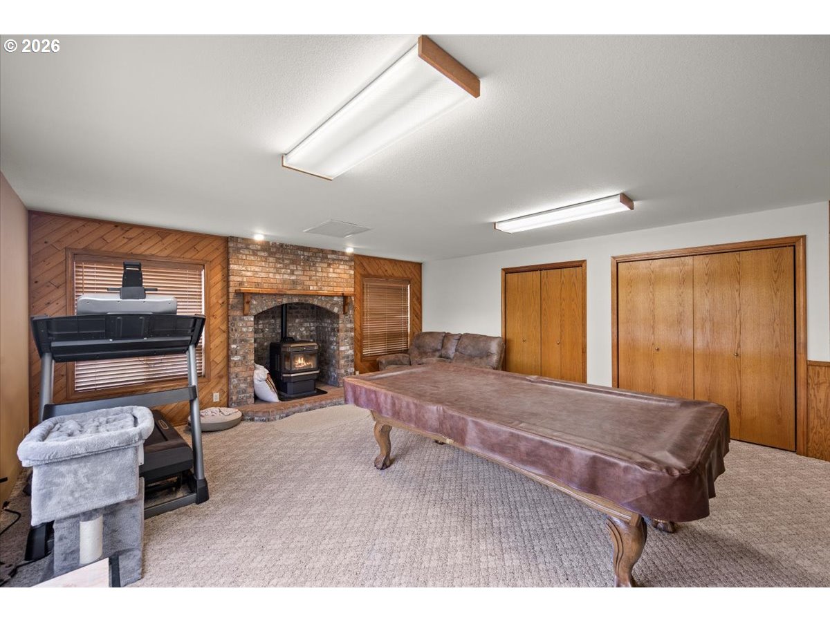 369 Upper Camp Loop Road Roseburg, OR 97470 - Photo 6 of 38 a living room with furniture a fireplace and a window