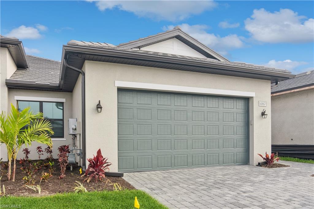 14867 Loggerhead Drive Naples, FL 34120 - Photo 1 of 21 a front view of a house with garden