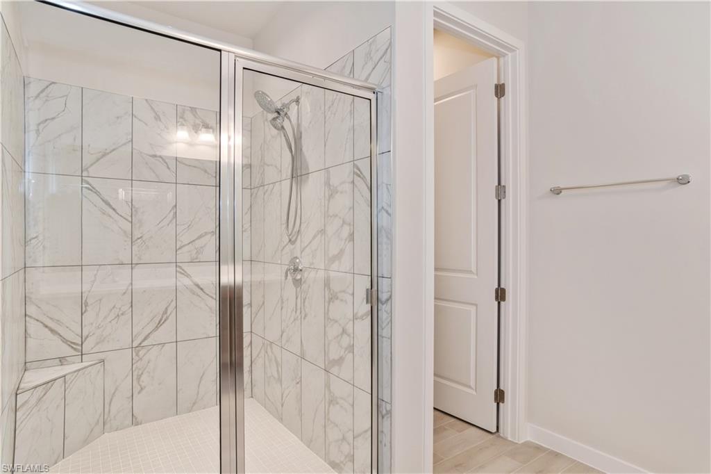 14867 Loggerhead Drive Naples, FL 34120 - Photo 12 of 21 a bathroom with a glass shower door