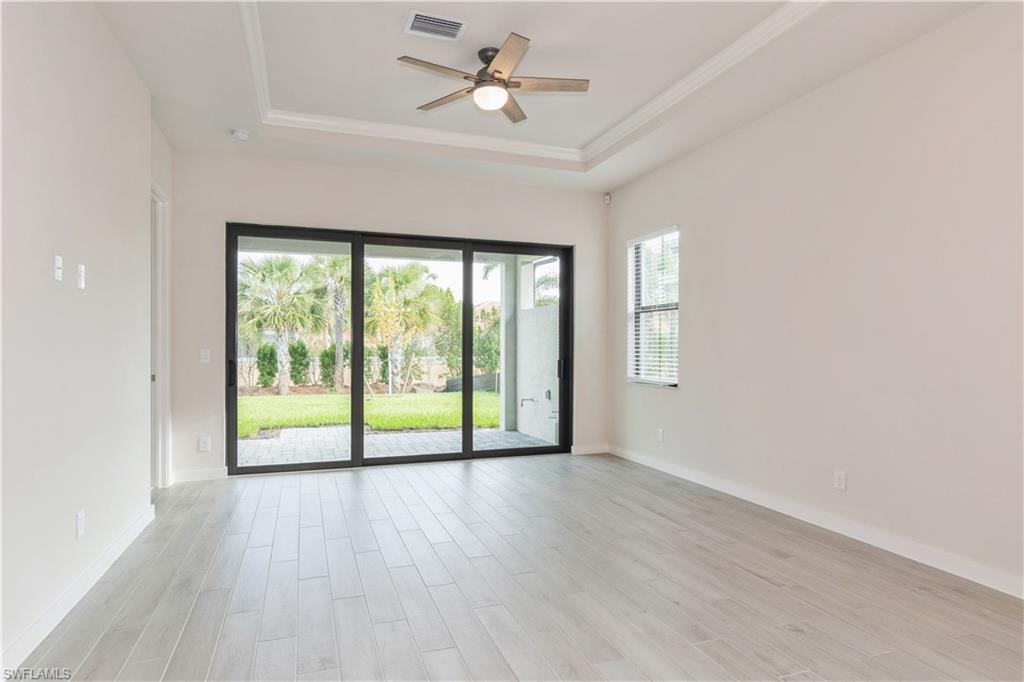 14867 Loggerhead Drive Naples, FL 34120 - Photo 18 of 21 a view of an empty room with a window and wooden floor