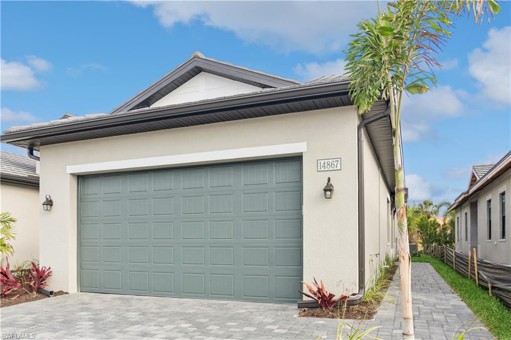 14867 Loggerhead Drive Naples, FL 34120 - Photo 2 of 21 a house that has a tree in front of the house