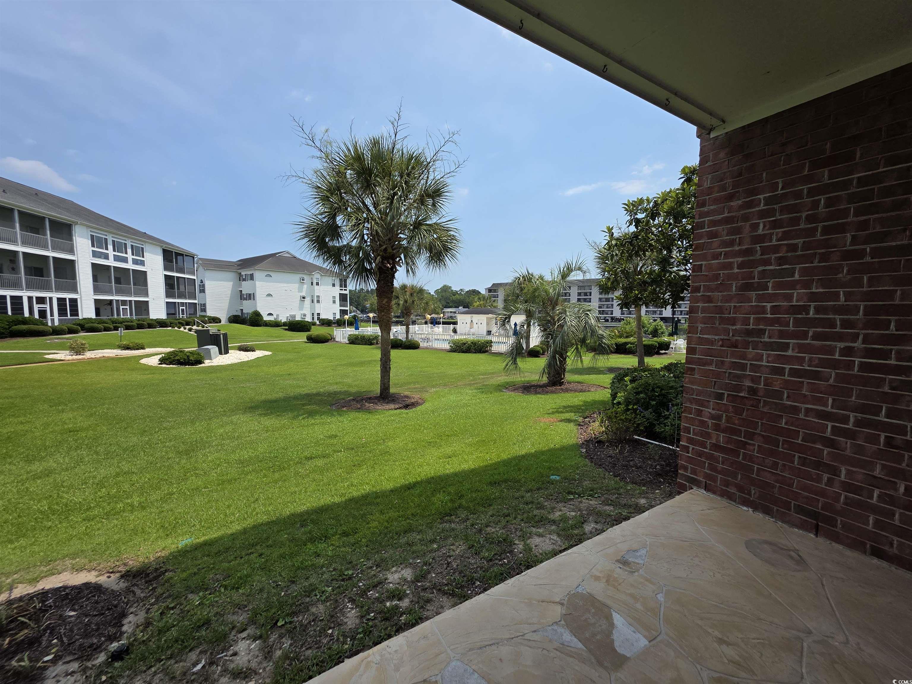 1514 Lanterns Rest Road, Unit 101 Myrtle Beach, SC 29579 - Photo 2 of 20 View of grassy yard with a residential view