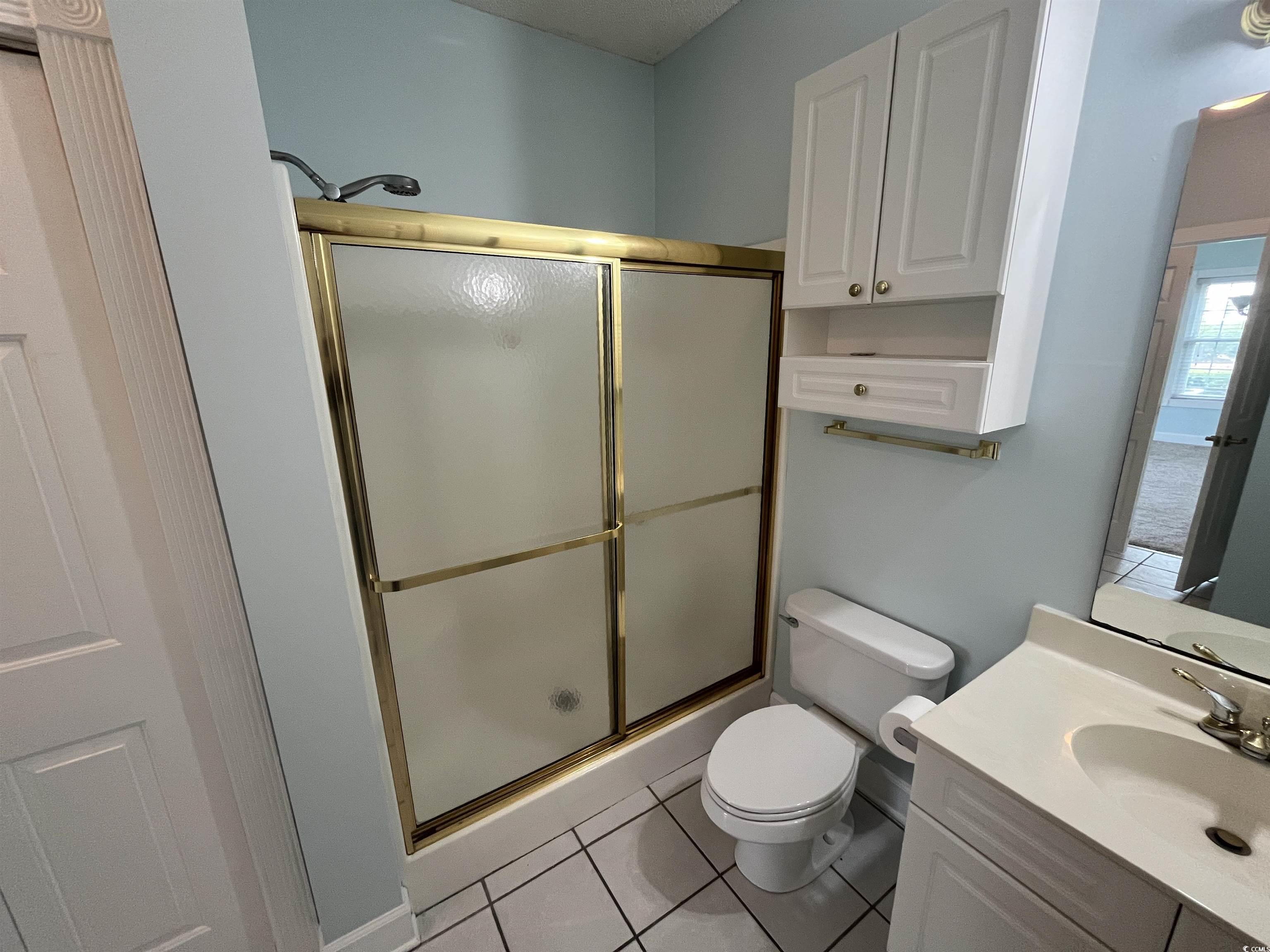 1514 Lanterns Rest Road, Unit 101 Myrtle Beach, SC 29579 - Photo 9 of 20 Full bathroom featuring a shower stall, vanity, and tile patterned flooring