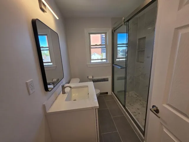 a bathroom with a sink toilet and shower