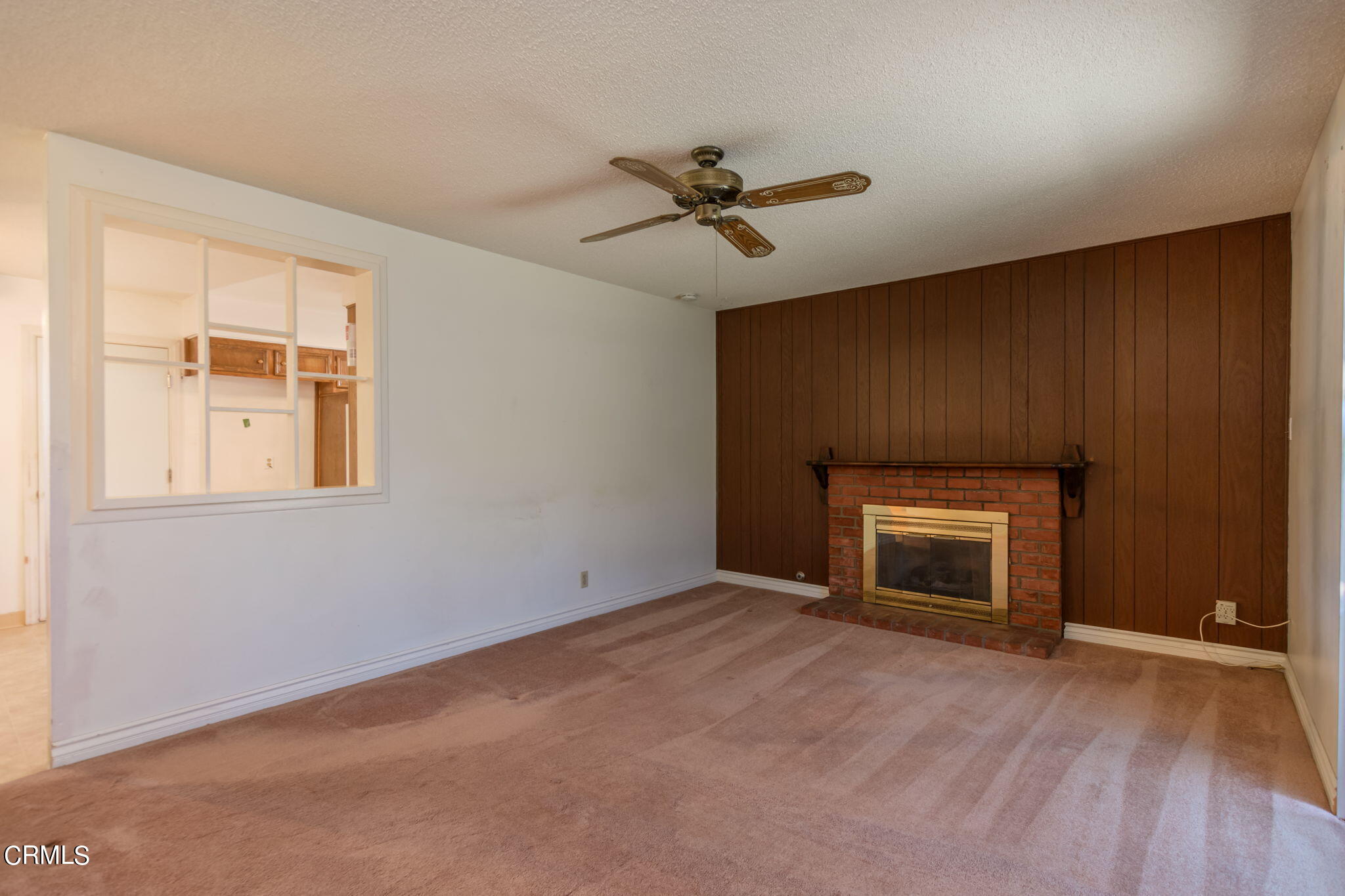 4410 Reeder Avenue Oxnard, CA 93033 - Photo 6 of 20 a view of empty room with a fireplace and a ceiling fan
